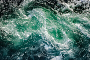 Blue waves of water of the river and the sea meet each other during high tide and low tide.