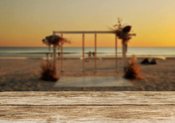 Wooden table top on the beach or sea.Party on the beach  sunset time concept.For montage product display or design key visual layout.View of copy space.