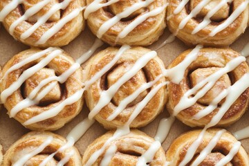 A row of cinnamon rolls with a white glaze on top