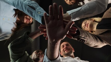 People stacking hands together in pile, sales team engaged in corporate teambuilding connected in teamwork help support coaching training unity concept, close up bottom view. - Powered by Adobe