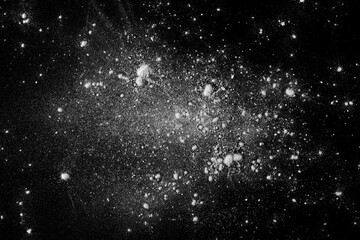 Powder white sugar scattered, isolated on black, top view and clipping