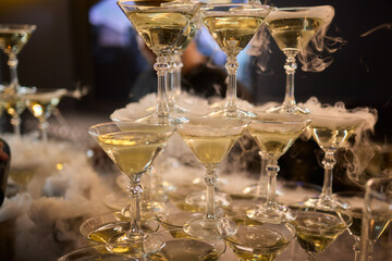 An elegant and stunning Champagne Tower adorned with a mysterious and enchanting smoke effect