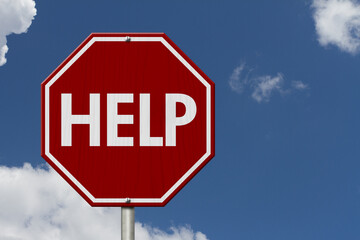  Red help stop sign against blue sky