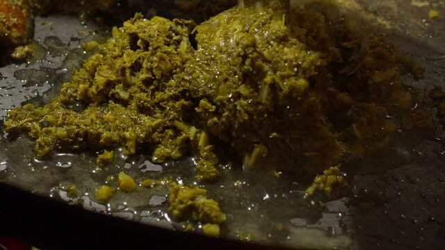 Slow Motion of cooking and making kale next to cham in a very big pan with onions and potatos. Making kale with potatoes and onions in a very big pan