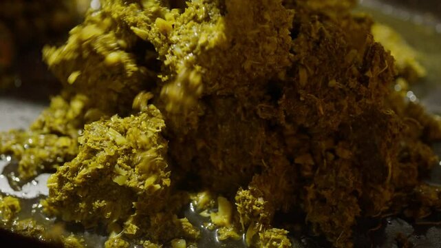 Slow Motion of cooking and making kale next to cham in a very big pan with onions and potatos. Making kale with potatoes and onions in a very big pan