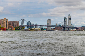 A view from the shore of the East river towards the Manhattan bridge in New York, in the fall