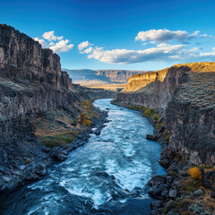Fototapeta premium Majestic river flowing through a canyon under a vibrant sky.