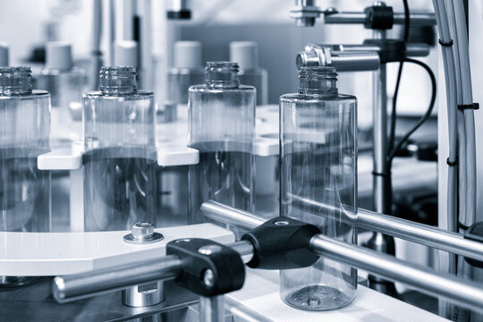 pharmaceutical industry, medicine pills are filling in the  bottle on production line machine conveyor at the medical factory. selective focus.
