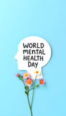 World mental health day concept. Paper human head symbol and flowers on blue background, with white tones