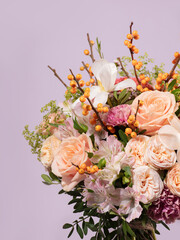Close-Up of a Floral Bouquet with Sea Buckthorn Branches on Lilac Background