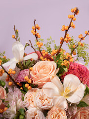 Close-Up of a Floral Bouquet with Sea Buckthorn Branches on Lilac Background