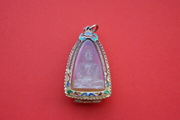 Buddha amulets on red background. Concept, faith and belief of Buddhist for holy to protect from...