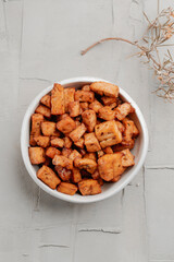 white ceramic bowl with marinated tofu cubes