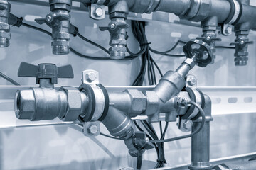 pipes and faucet valves of heating system in a boiler room