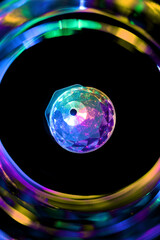Close up of the colorful party light surrounded by the vortex of blurry colors