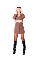 Confident model showcases stylish brown cutout dress paired with knee-high black boots in studio...