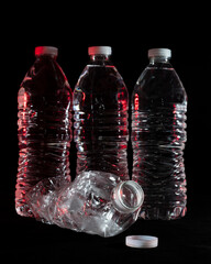 Plastic water bottles on a black background