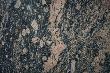 A close-up of a granite stone highlighting its rich mineral diversity and sparkling crystals.