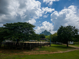 A beautiful view of the side face of the Morros de San Juan de los Morros, in Guárico, Venezuela, with a stunning backdrop of a clear day featuring a blue sky filled with clouds.