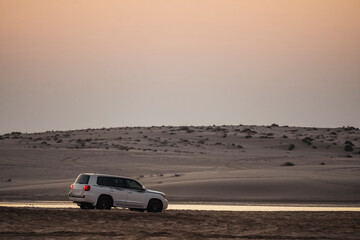 Desert landscape and off-road vehicles on desert safari in Doha, Qatar