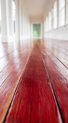 Obraz premium A long hallway with red wood floors and white walls