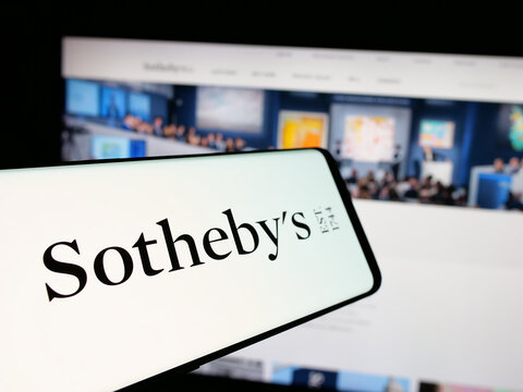 Stuttgart, Germany - 12-30-2024: Smartphone with logo of British luxury auctioneer company Sotheby's on screen in front of business website. Focus on center-left of phone display.