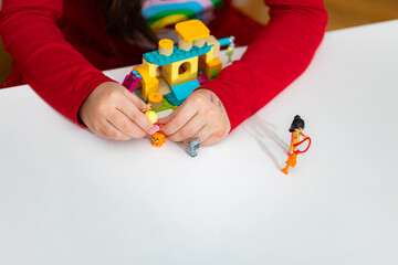 Obraz premium Closeup of kid playing LEGO Friends