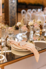 Decorating a hall for an expensive luxury wedding in a restaurant with lights, flowers, and seating details for guests
