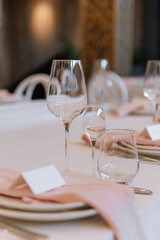 Decorating a hall for an expensive luxury wedding in a restaurant with lights, flowers, and seating details for guests