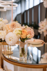 Decorating a hall for an expensive luxury wedding in a restaurant with lights, flowers, and seating details for guests