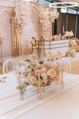 Decorating a hall for an expensive luxury wedding in a restaurant with lights, flowers, and seating details for guests