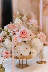 Decorating a hall for an expensive luxury wedding in a restaurant with lights, flowers, and seating details for guests