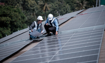Engineers walking on roof inspect and check solar cell panel by hold equipment box and radio...