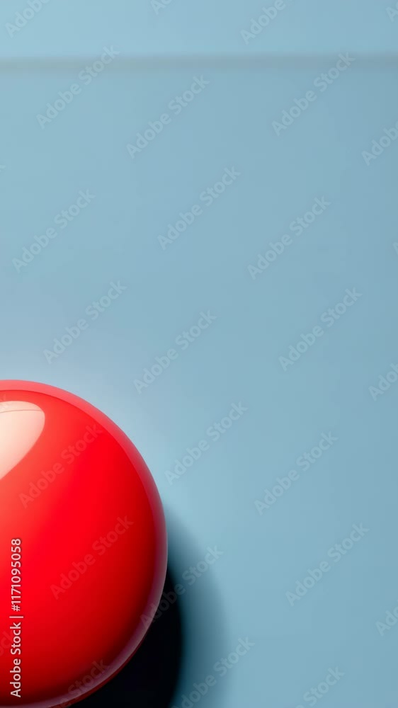 Poster bright red spherical object rests on a blue surface creating a striking contrast