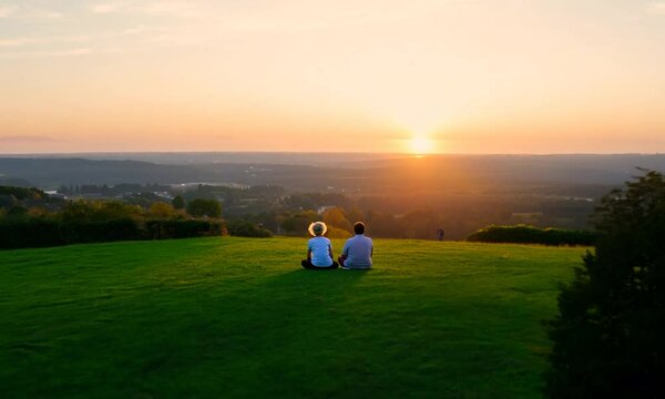 Elderly Couple Sitting in Park at Sunset  