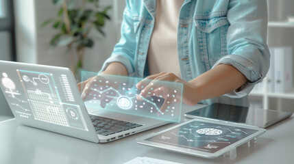 A light-skinned, middle-aged person is interacting with a holographic interface projected onto a laptop and tablet