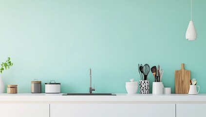Minimalist kitchen counter with utensils, sink, and mint wall.