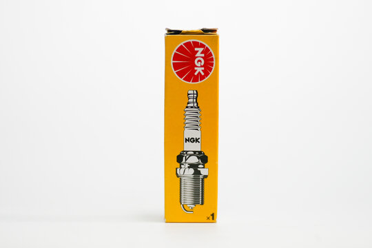 Close up a pack of NGK Spark Plug isolated on white background