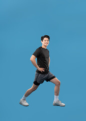  ImageFull body image of Asian guy wearing workout clothes and posing on a blue background