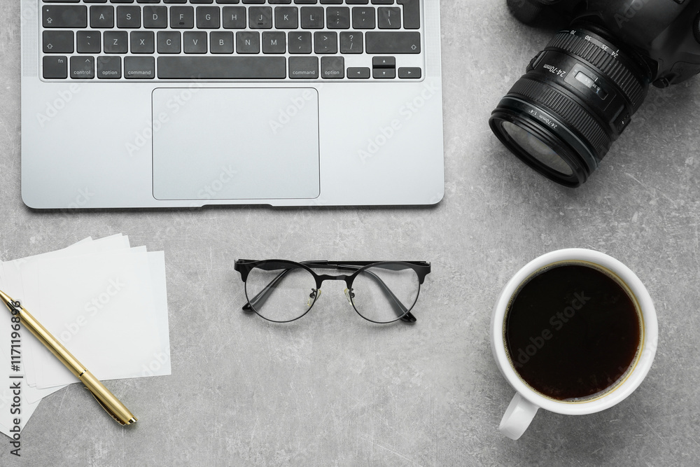 Wall mural flat lay composition with camera and laptop on grey textured table