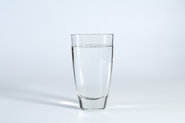 Refreshing soda water in glass on white background