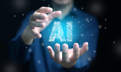 Artificial Intelligence concept. Hands of a man carry an AI text with circuit pattern, glowing bright in the dark. Ai technology.