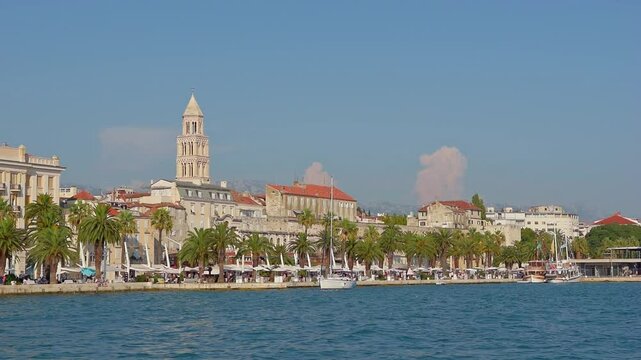 Stunning Waterfront View of Split, Croatia, Highlighting the Historic St. Domnius Cathedral Bell Tower and Palm-Lined Riva Promenade