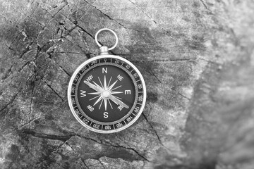 Classic navigation compass on natural background