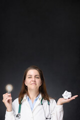 Doctor with glowing light bulb and crumpled paper