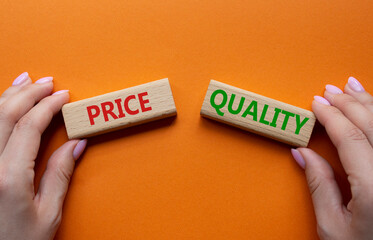 Price and Quality symbol. Concept word Price and Quality on wooden blocks. Businessman hand....