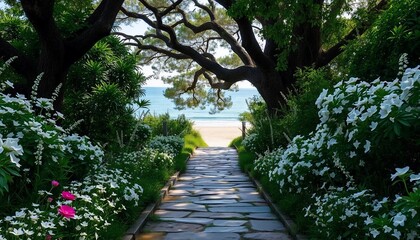 The stone path leading to the sea is lined with blooming flowers, surrounded by lush green trees and white wildflowers on both sides of it