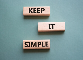 Keep it Simple symbol. Concept words Keep it Simple on wooden blocks. Beautiful grey green...