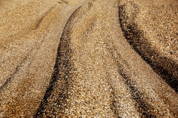 Gravel and pebbles being added to a beach as part of coastal defence.