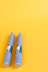 Diabetes control pens with semaglutide on a vibrant yellow background